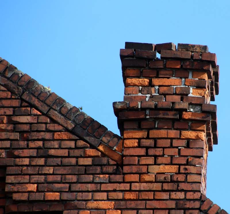 Signs Your Hinsdale Home Needs a Chimney Inspection Damaged chimney on an Hinsdale home showing cracks and missing mortar